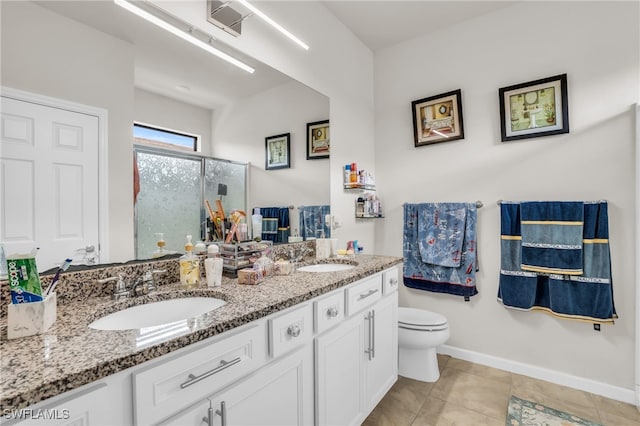 bathroom with vanity, toilet, walk in shower, and tile patterned flooring