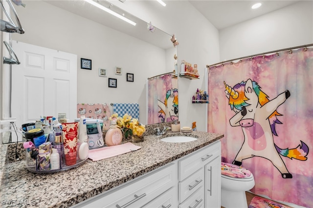 bathroom with a shower with shower curtain, toilet, and vanity