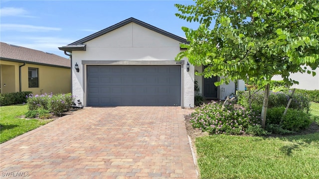 ranch-style house with a garage and a front yard