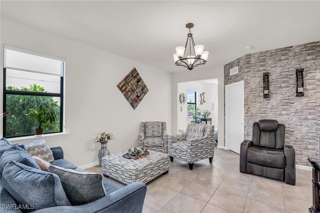 tiled living room with an inviting chandelier