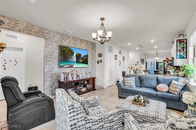 tiled living room featuring an inviting chandelier