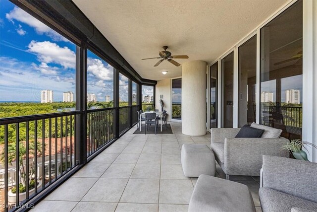 7575 Pelican Bay Blvd Unit 403, Naples, FL 34108 - sunroom featuring tile patterned floors, a ceiling fan, floor to ceiling windows, and plenty of natural light