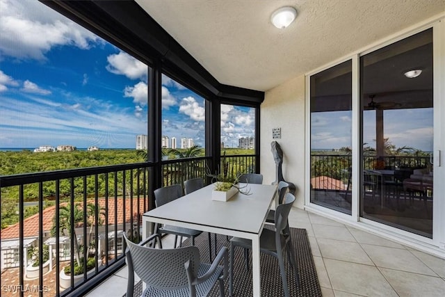 7575 Pelican Bay Blvd Unit 403, Naples, FL 34108 - sunroom / solarium with tile patterned floors, a textured ceiling, outdoor dining area, and plenty of natural light