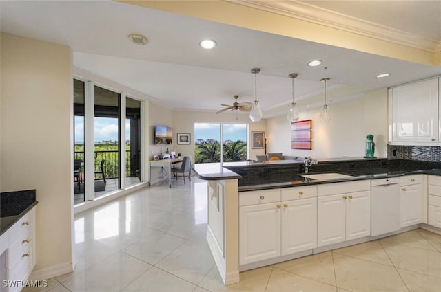 kitchen featuring light tile patterned flooring, white dishwasher, kitchen peninsula, hanging light fixtures, and white cabinets