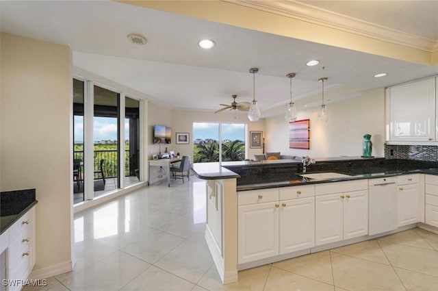 7575 Pelican Bay Blvd Unit 403, Naples, FL 34108 - kitchen featuring a peninsula, crown molding, white dishwasher, and light tile patterned floors