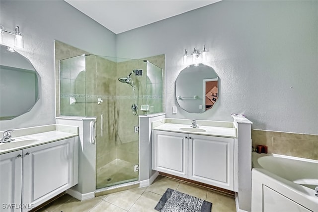 bathroom with a stall shower, a sink, and tile patterned floors