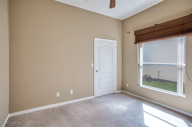 unfurnished room featuring ceiling fan and light carpet