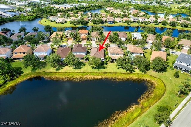 birds eye view of property featuring a water view and a residential view