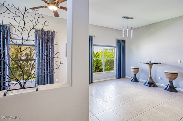 interior space with ceiling fan and tile patterned flooring