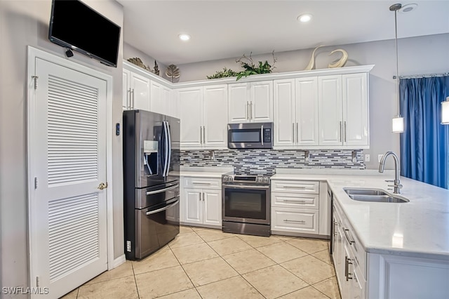 kitchen with white cabinets, backsplash, decorative light fixtures, stainless steel appliances, and sink