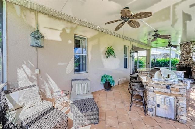 view of patio featuring exterior kitchen and ceiling fan