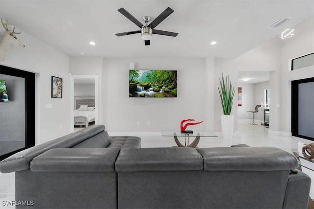 tiled living room with ceiling fan