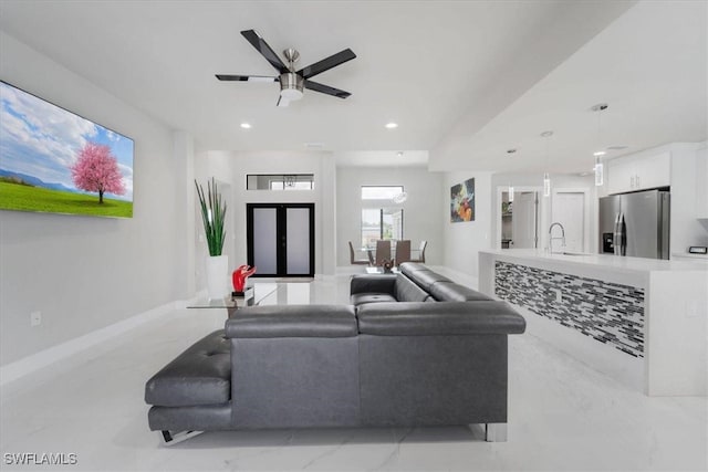 living room with ceiling fan and sink