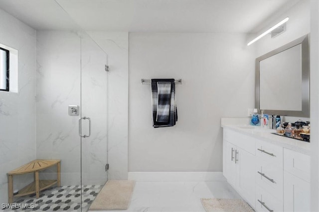 bathroom featuring walk in shower and vanity