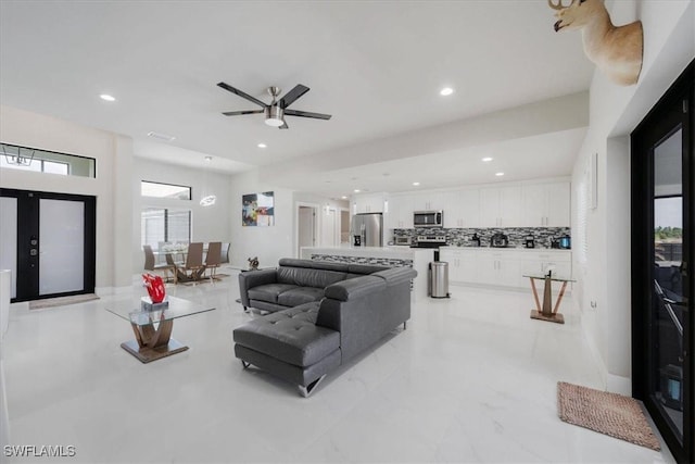 living room with a healthy amount of sunlight and ceiling fan