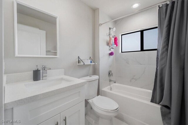 full bathroom with vanity, toilet, and shower / tub combo