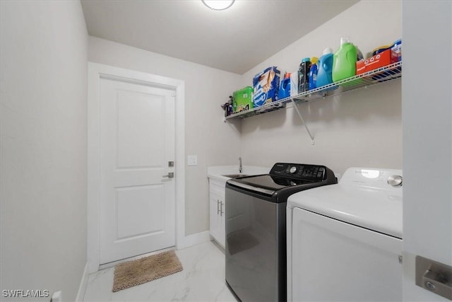 laundry room with cabinets and washer and clothes dryer