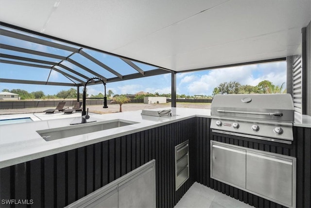 view of patio / terrace featuring area for grilling, a lanai, and sink