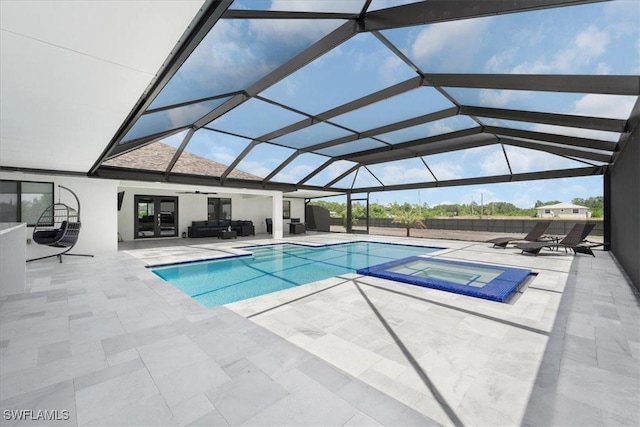 view of pool featuring a lanai, an in ground hot tub, and a patio area