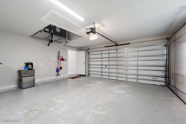 garage with stainless steel refrigerator and a garage door opener