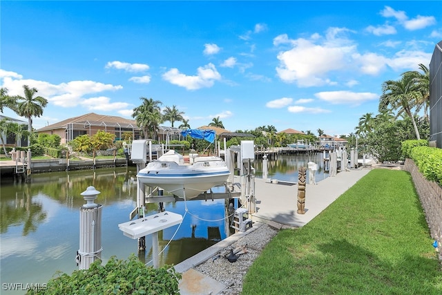 view of dock with glass enclosure, a yard, and a water view