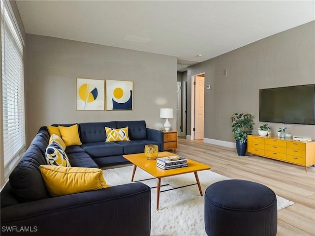 living room featuring light wood-type flooring and baseboards