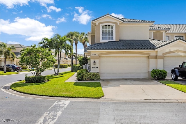 view of front of house featuring a garage and a front lawn