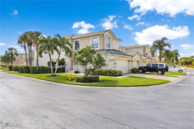 view of front of property with a garage and a front yard