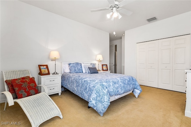 carpeted bedroom featuring a closet and ceiling fan