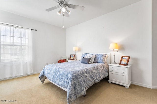 bedroom featuring ceiling fan and light carpet