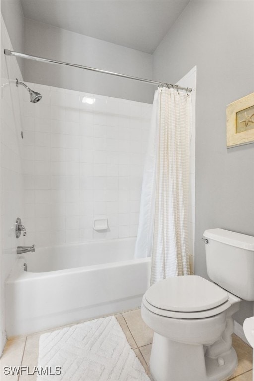 bathroom featuring tile patterned floors, toilet, and shower / bath combo