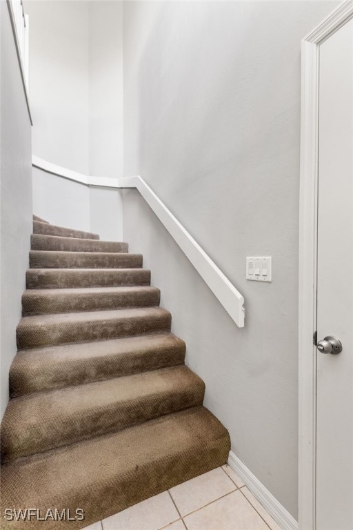 staircase featuring tile patterned floors