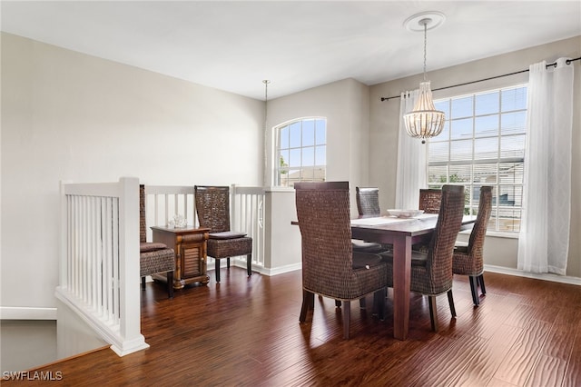 dining area featuring dark hardwood / wood-style flooring and a chandelier