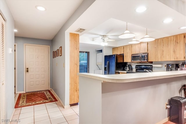 kitchen with pendant lighting, kitchen peninsula, black refrigerator with ice dispenser, and range