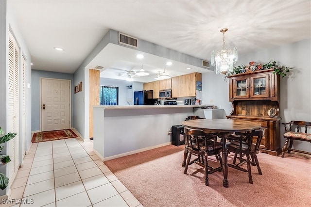 dining area with light carpet and ceiling fan with notable chandelier