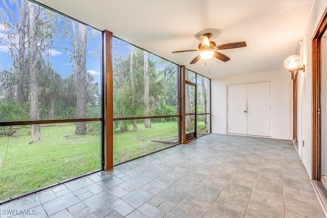 unfurnished sunroom with ceiling fan