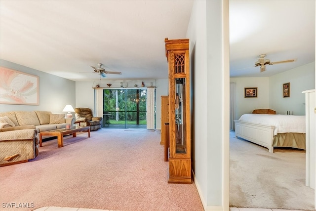 carpeted living room with ceiling fan