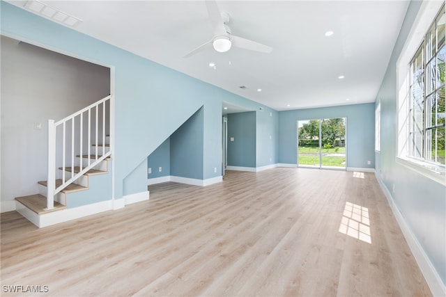 unfurnished living room with light wood-type flooring and ceiling fan