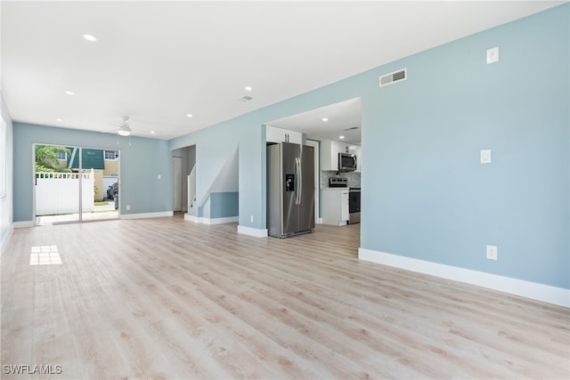 unfurnished living room featuring ceiling fan and light hardwood / wood-style flooring