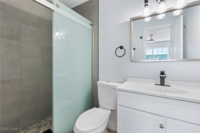 bathroom with ceiling fan, vanity, a shower, and toilet