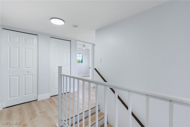 stairs featuring wood-type flooring