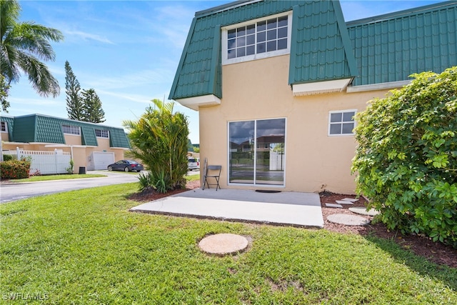 rear view of property featuring a lawn