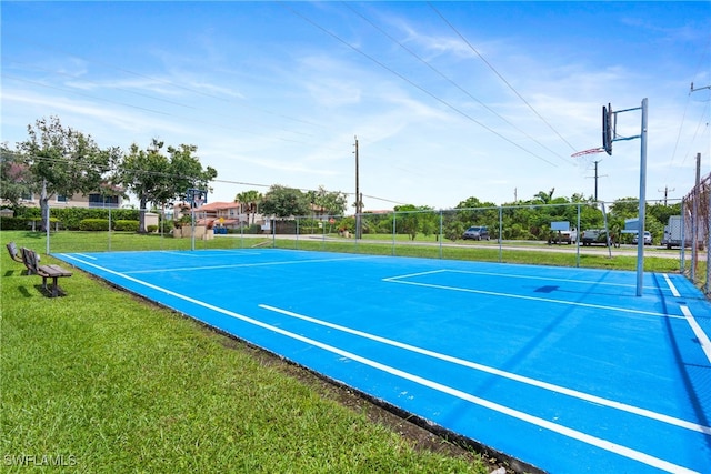 view of tennis court with a lawn