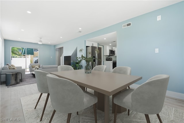 dining space featuring light wood-type flooring and ceiling fan