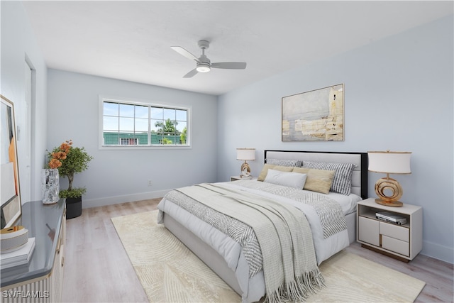 bedroom with light hardwood / wood-style flooring and ceiling fan