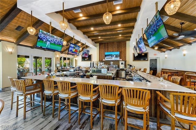 bar with wood ceiling, decorative light fixtures, hardwood / wood-style flooring, and lofted ceiling with beams