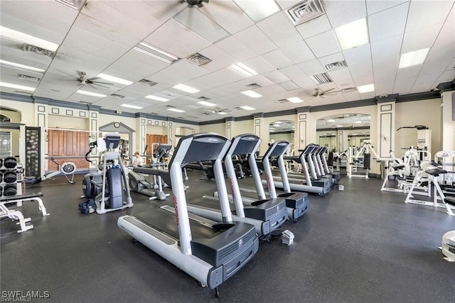 workout area with ceiling fan and a drop ceiling