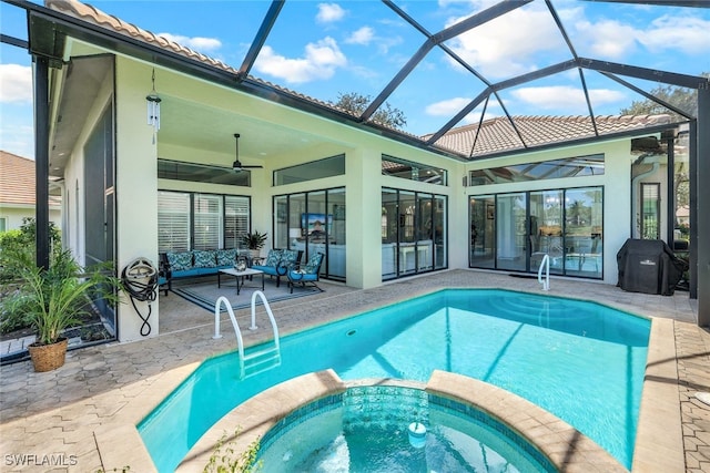 view of pool with outdoor lounge area, glass enclosure, ceiling fan, and a patio