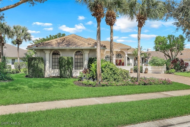 mediterranean / spanish-style house with a front lawn