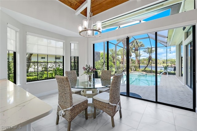 sunroom featuring beamed ceiling and a notable chandelier